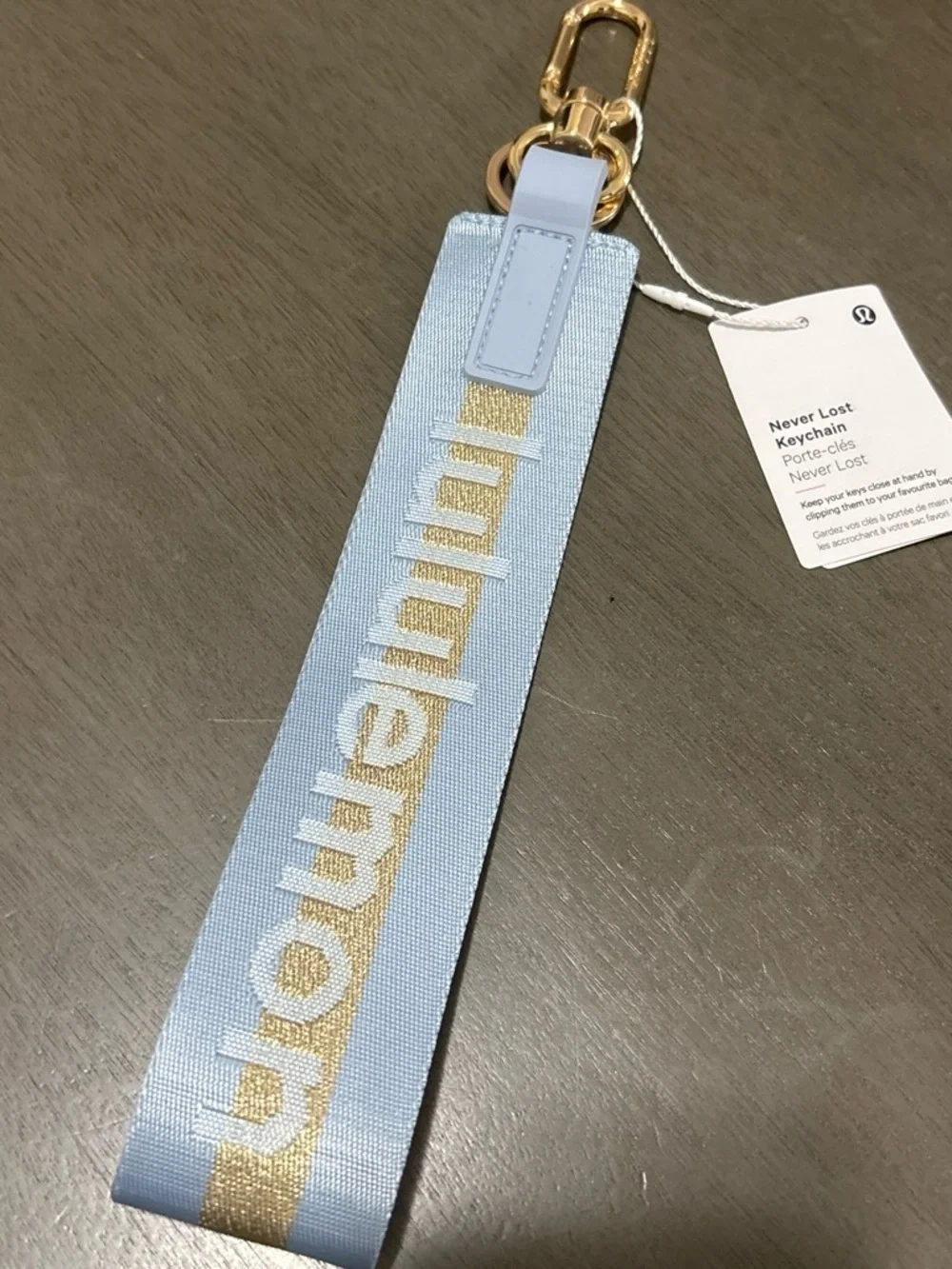 lululemon athletica light blue keychain wristlet with gold stripe